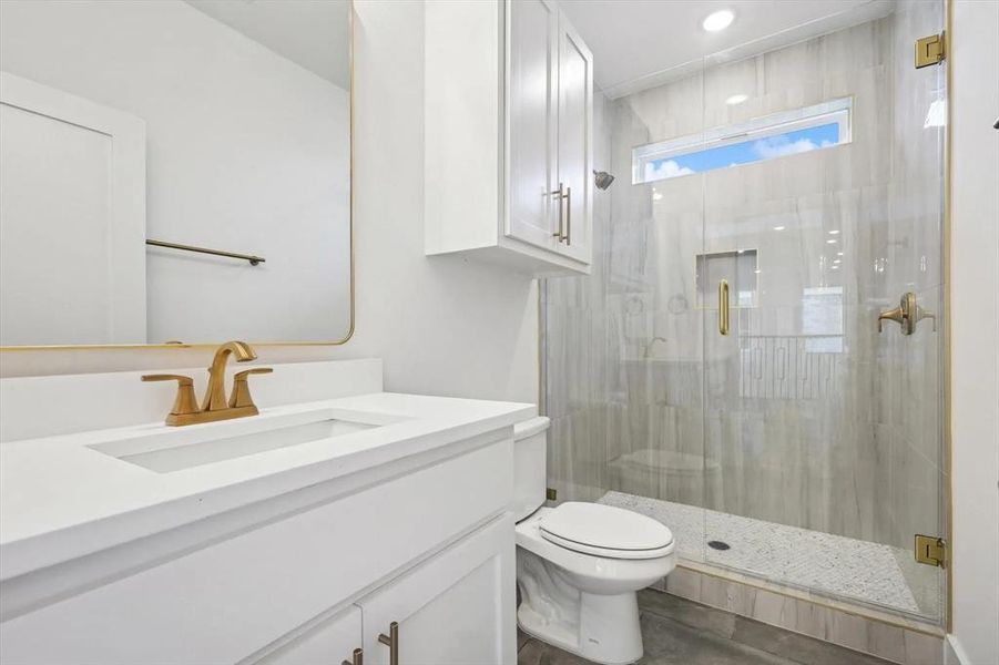Bathroom with a shower stall and vanity