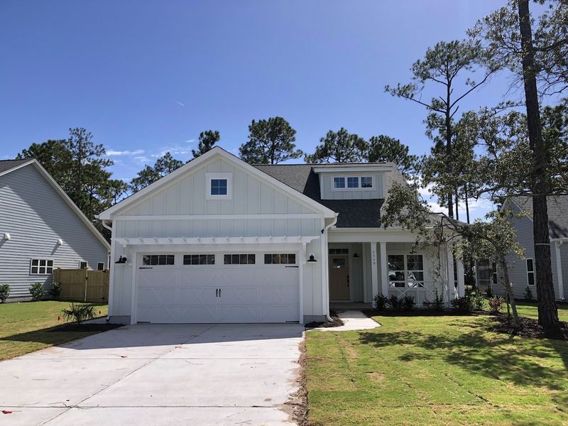 Front exterior of a new home in Osprey Landing, Southport, NC, highlighting curb appeal (Image 1). Front exterior of a new home in Osprey Landing, Southport, NC, highlighting curb appeal (Image 1).