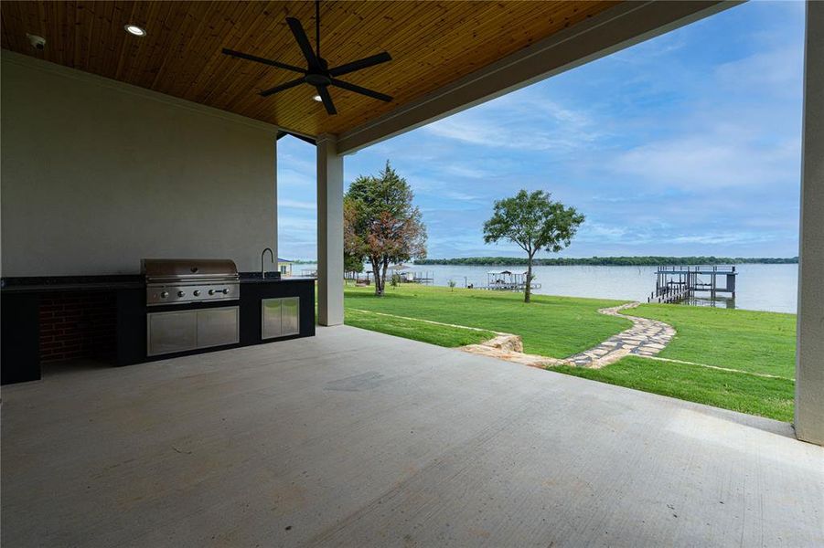 View of First Floor patio featuring an outdoor kitchen, area for grilling, a sink, and a water view View of First Floor patio featuring an outdoor kitchen, area for grilling, a sink, and a water view