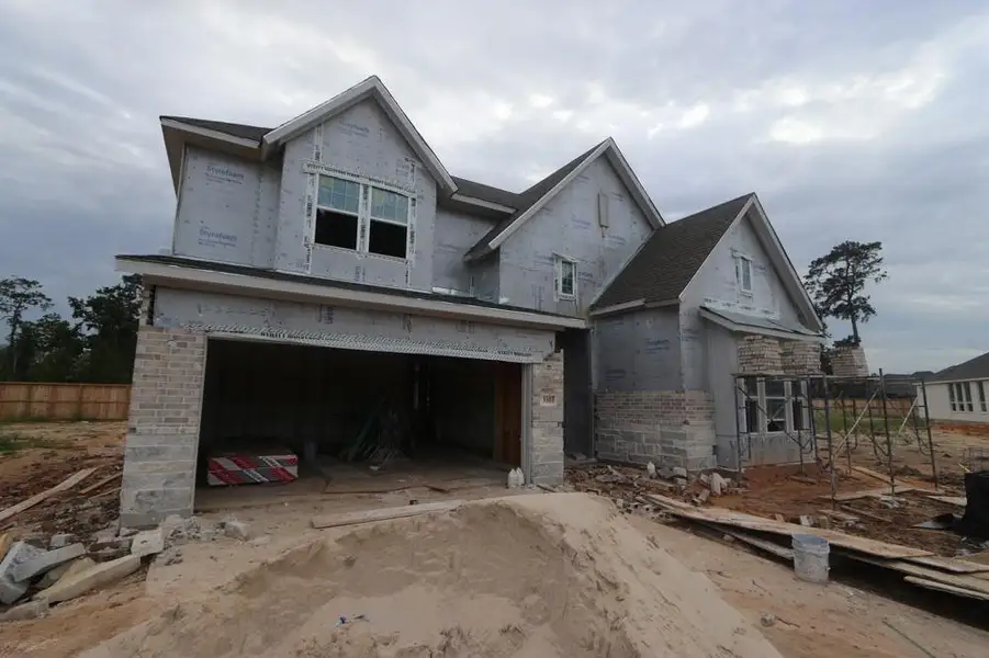 Front exterior of a new home in Grand Central Park 55' Homesites, Conroe, TX, highlighting curb appeal (Image 2). Front exterior of a new home in Grand Central Park 55' Homesites, Conroe, TX, highlighting curb appeal (Image 2).