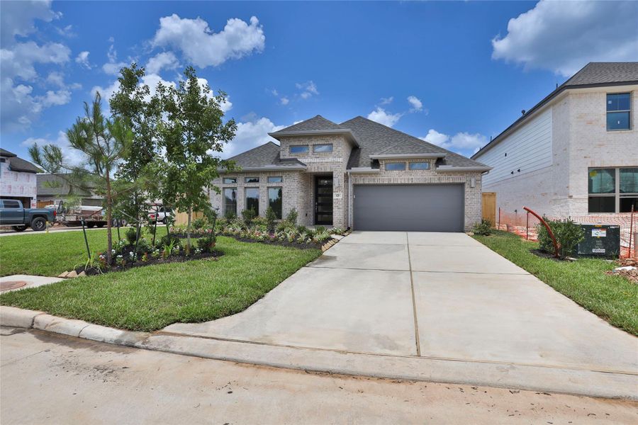 Front exterior of a new home in Grand Central Park 50', Conroe, TX, highlighting curb appeal (Image 14). Front exterior of a new home in Grand Central Park 50', Conroe, TX, highlighting curb appeal (Image 14).