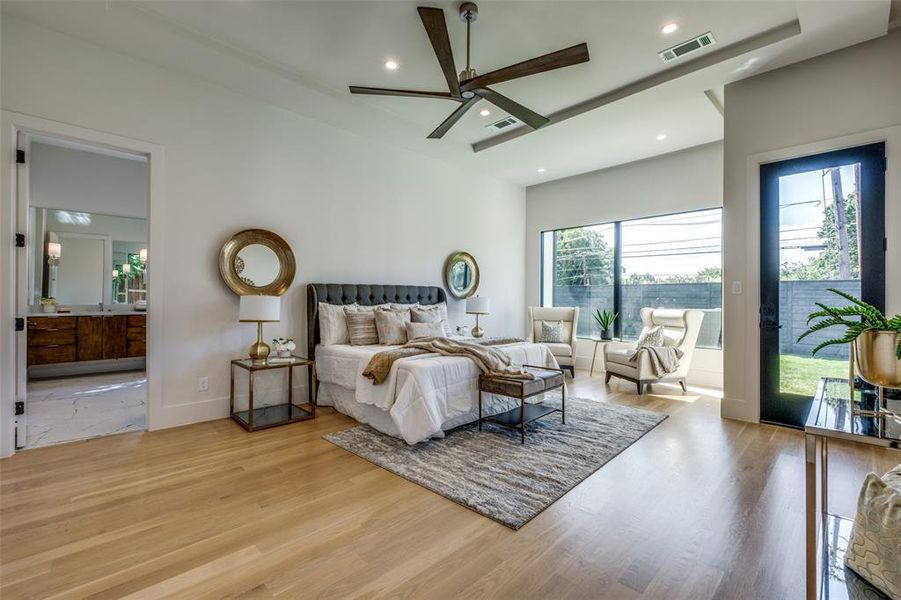 Bedroom featuring multiple windows, light hardwood / wood-style flooring, and ceiling fan