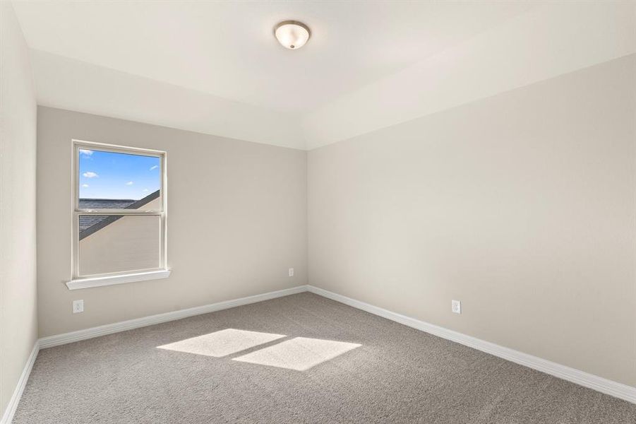 Your secondary bedroom features plush carpet, fresh paint, closet, and a large window that lets in plenty of natural lighting.