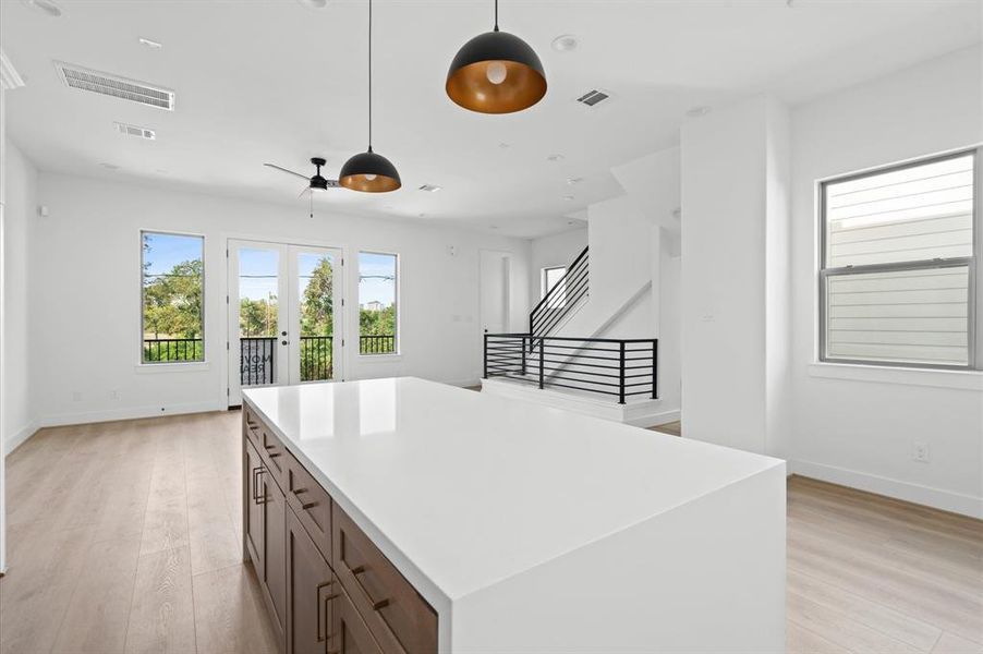 More cabinetry space behind the waterfall edge island.