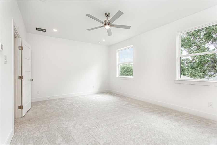 Spare room with light carpet, baseboards, ceiling fan, and recessed lighting