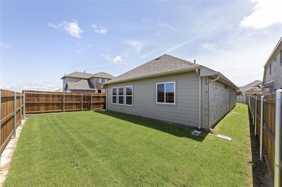 Rear view of house featuring a yard