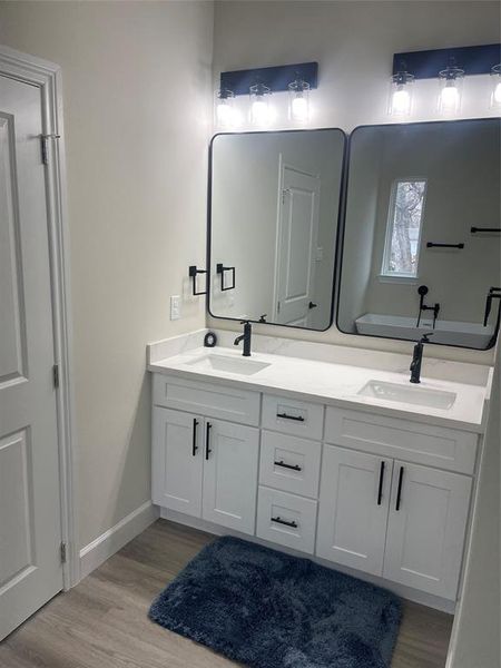 Double mirrors and sinks in the primary ensuite bathroom.