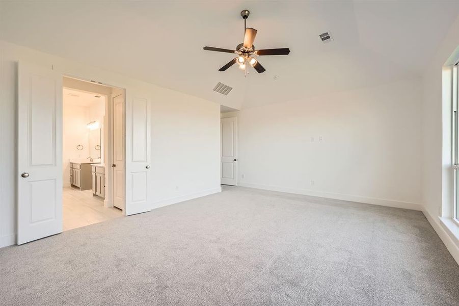 Unfurnished room featuring ceiling fan and light colored carpet