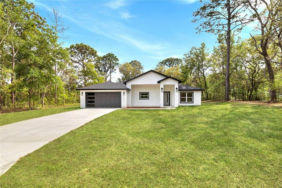 Front exterior of a new home in , Citrus Springs, FL, highlighting curb appeal (Image 2). Front exterior of a new home in , Citrus Springs, FL, highlighting curb appeal (Image 2).