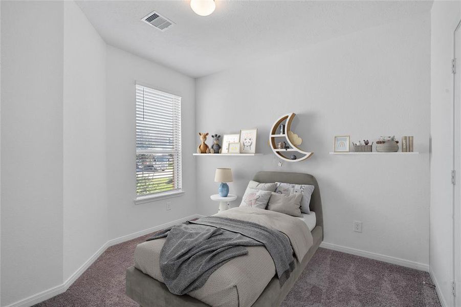 Secondary bedroom features plush carpet, and a large window with privacy blinds.