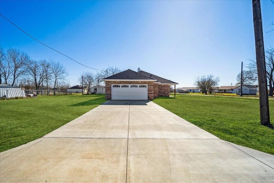 Single story home featuring a garage and a front yard