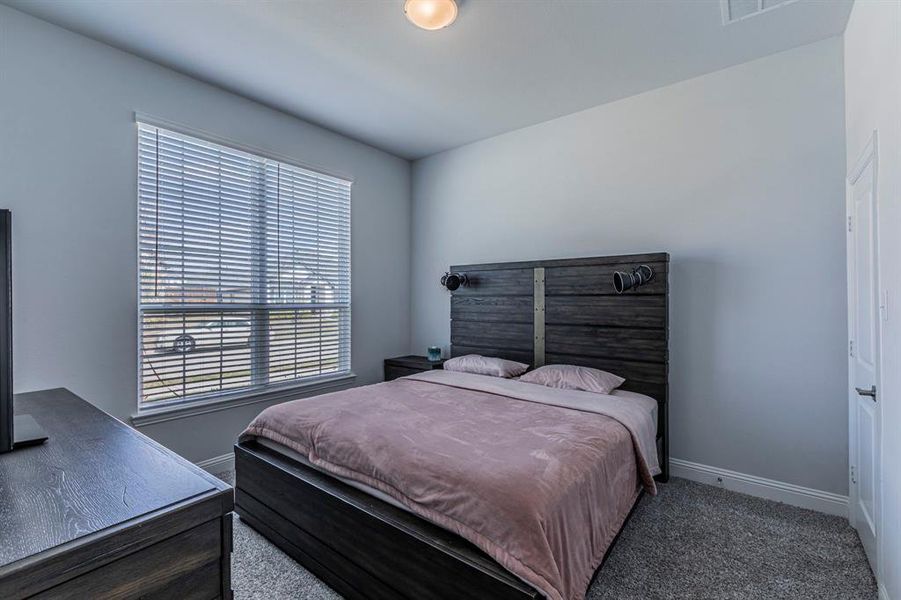 Carpeted bedroom with baseboards Carpeted bedroom with baseboards