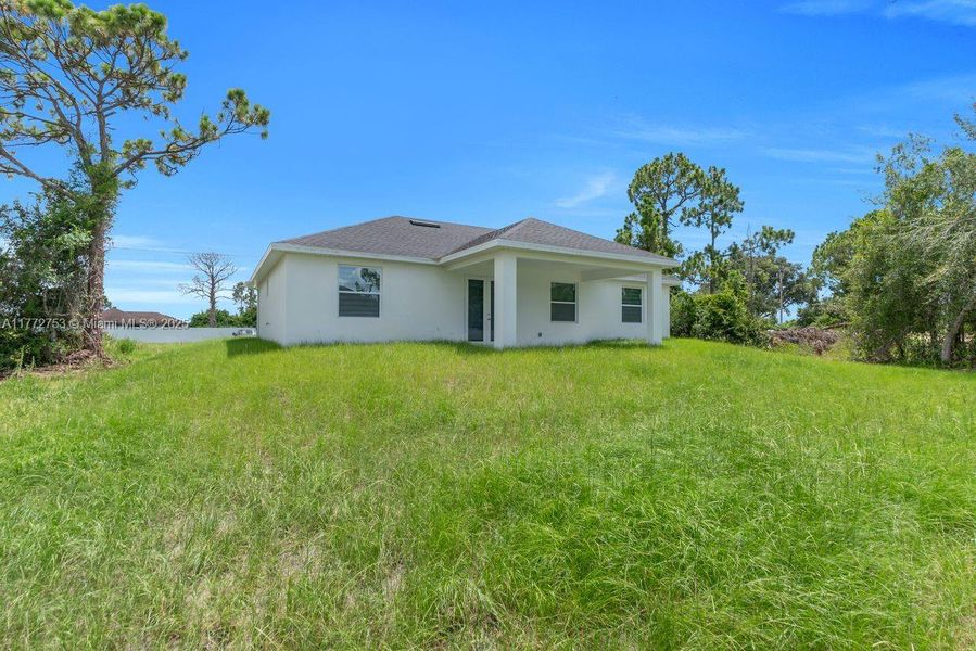 Front exterior of a new home in , Lehigh Acres, FL, highlighting curb appeal (Image 1).