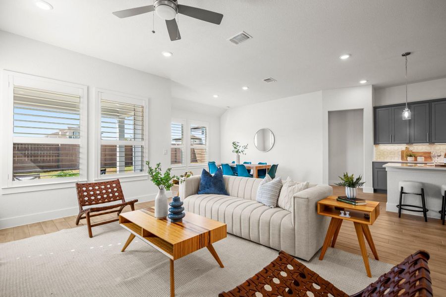 Living area featuring light wood finished floors, recessed lighting, and a ceiling fan