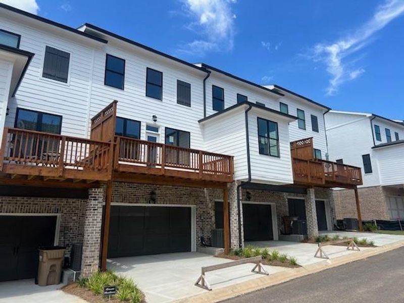 Front exterior of a new home in Palisades Townhomes, Cumming, GA, highlighting curb appeal (Image 1).