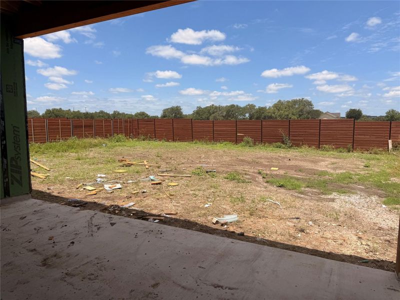 A spacious backyard awaits, fully fenced for privacy and outdoor enjoyment.