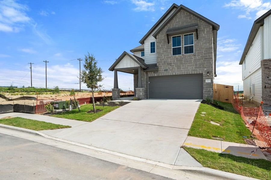 Front exterior of a new home in Terrace Collection At Turner's Crossing, Buda, TX, highlighting curb appeal (Image 27).