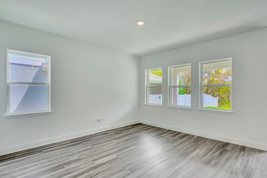 Representative unfurnished interior of a home built from the Faulkner by Rockwell Homes in Northlake At Ovation, Winter Garden (Image 27).