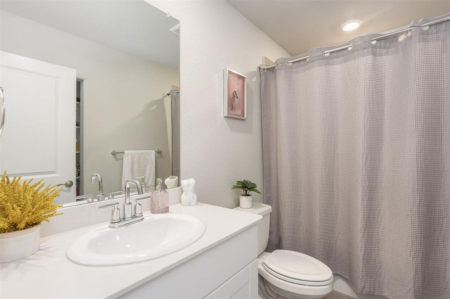 Full bath with vanity and a shower with shower curtain Full bath with vanity and a shower with shower curtain