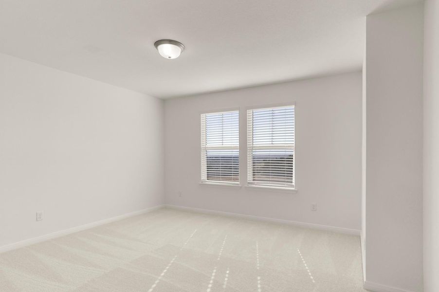 Empty room with light colored carpet and baseboards Empty room with light colored carpet and baseboards