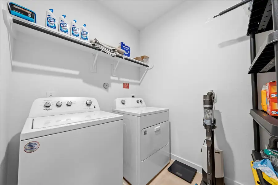 The well-designed laundry room offers side-by-side washer and dryer placement, along with an overhead shelf that provides practical and organized storage. The well-designed laundry room offers side-by-side washer and dryer placement, along with an overhead shelf that provides practical and organized storage.