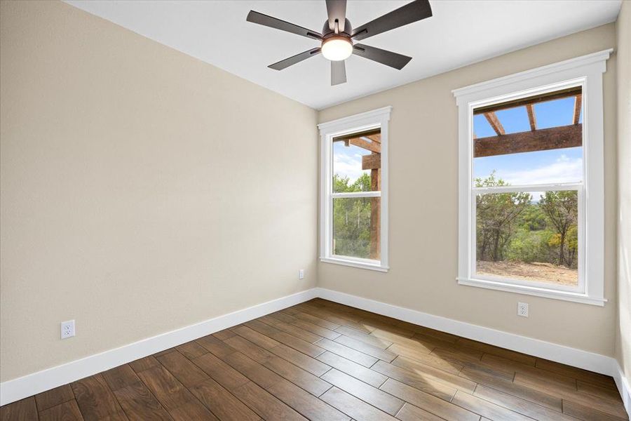 Empty room with baseboards and wood finished floors Empty room with baseboards and wood finished floors