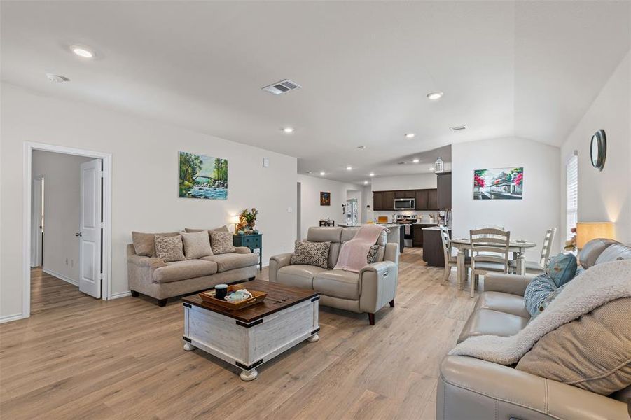 Spacious open-layout living area with modern recessed lighting and seamless flow into the kitchen and dining spaces. Spacious open-layout living area with modern recessed lighting and seamless flow into the kitchen and dining spaces.