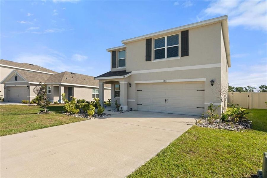 Front exterior of a new home in Silverstone North, Palmetto, FL, highlighting curb appeal (Image 26).