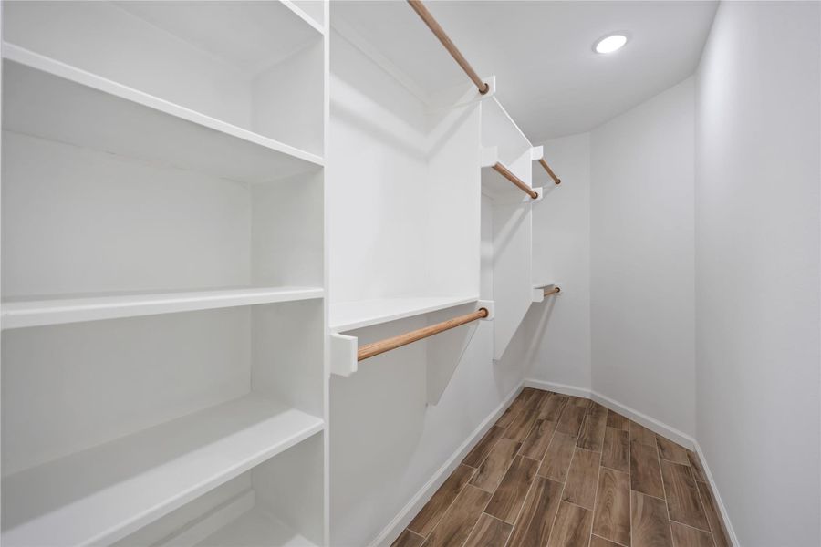 Large walk-in closet with built-in shelving and hanging space for easy organization.