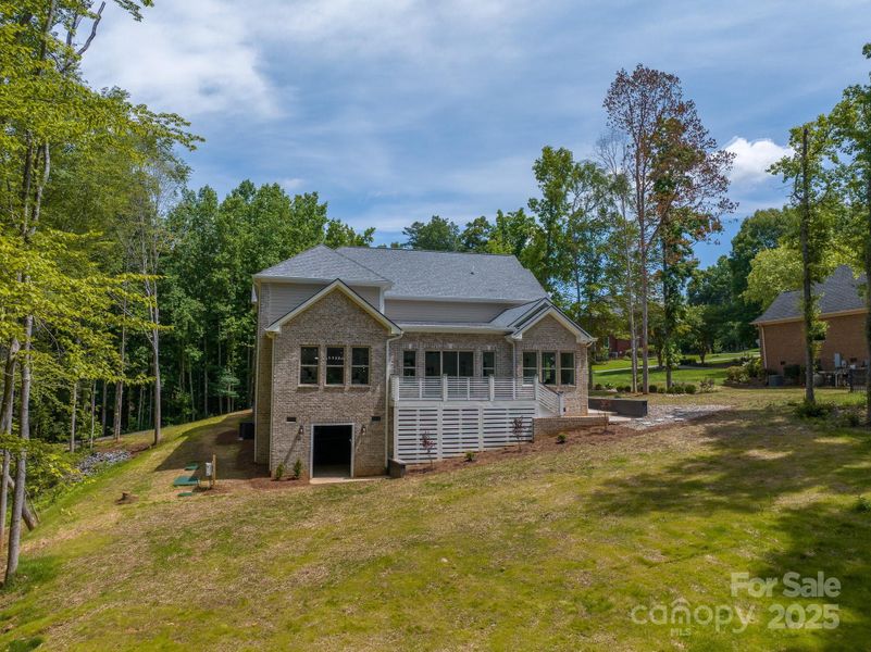 View from rear of home - Garage door leads to walk in crawlspace that can be finished if desired View from rear of home - Garage door leads to walk in crawlspace that can be finished if desired