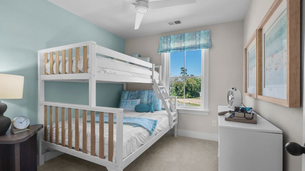 Secondary bedroom with 2 large windows on adjacent walls in a DRB Homes Brookgreen model home Secondary bedroom with 2 large windows on adjacent walls in a DRB Homes Brookgreen model home