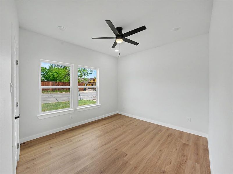 Unfurnished room with light wood-type flooring, a ceiling fan, and recessed lighting