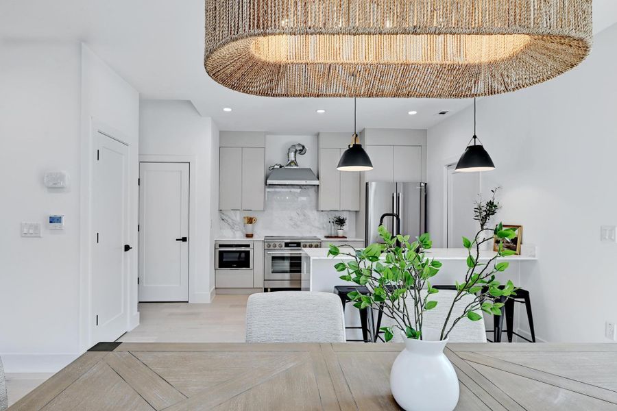 Dining area with recessed lighting and light wood-style flooring