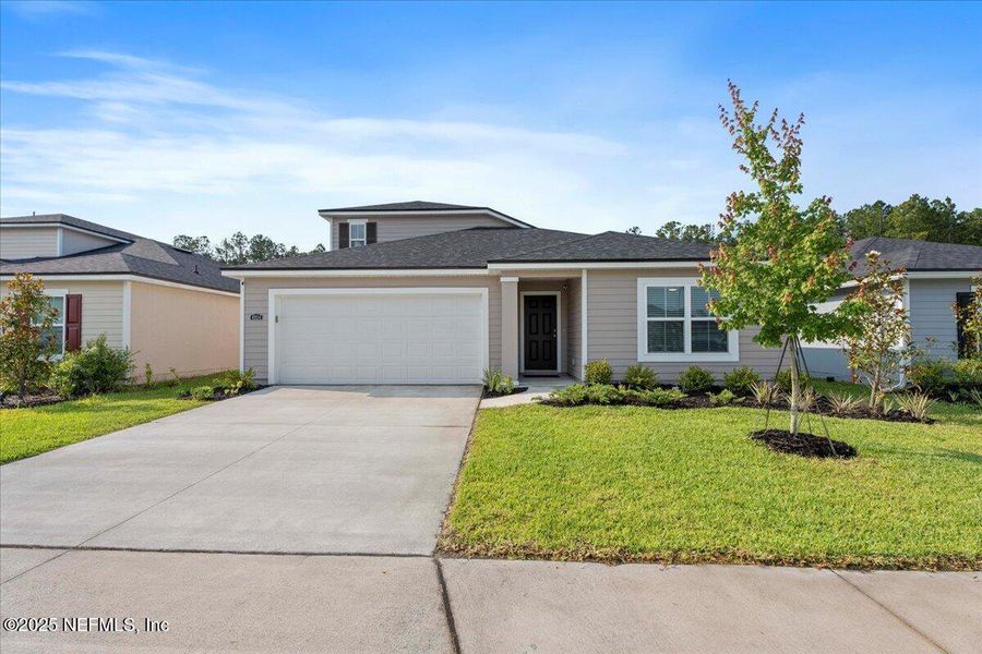 Front exterior of a new home in Dunns Crossing, Jacksonville, FL, highlighting curb appeal (Image 1). Front exterior of a new home in Dunns Crossing, Jacksonville, FL, highlighting curb appeal (Image 1).