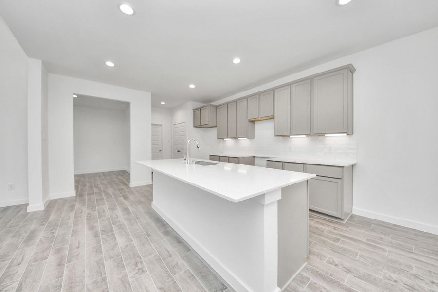 The extended counter area adds both practicality and style, making meal preparation a breeze. Every detail is thoughtfully designed to enhance the kitchen's functionality and aesthetic appeal. Sample photo of completed home with similar floor plan. Actual colors and selections may vary. The extended counter area adds both practicality and style, making meal preparation a breeze. Every detail is thoughtfully designed to enhance the kitchen's functionality and aesthetic appeal. Sample photo of completed home with similar floor plan. Actual colors and selections may vary.