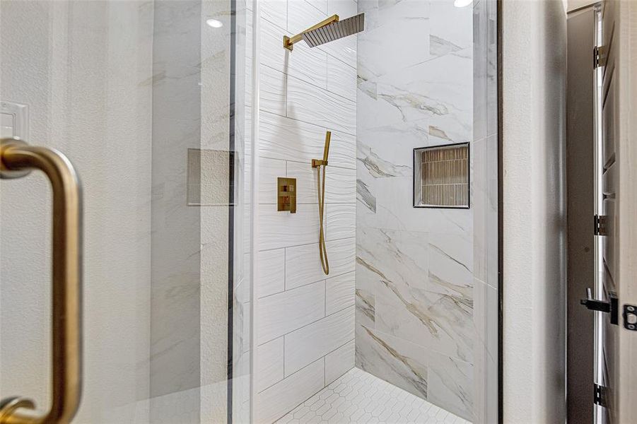 Full bathroom with a marble finish shower