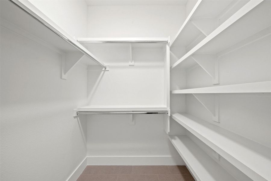 Ample shelving and hanging space in this well-organized walk-in closet. Ample shelving and hanging space in this well-organized walk-in closet.