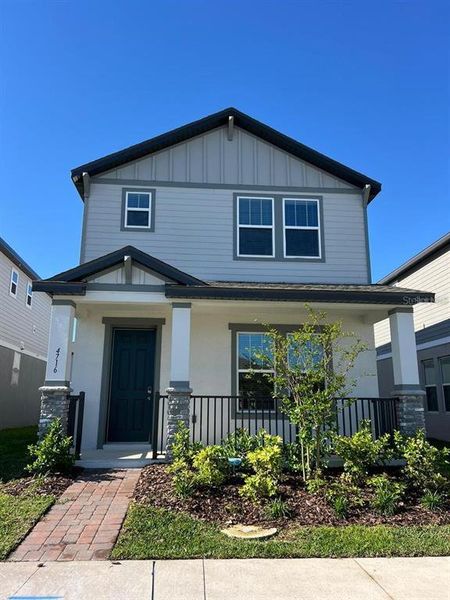 Front exterior of a new home in The Meadow at Crossprairie Bungalows, St. Cloud, FL, highlighting curb appeal (Image 2).