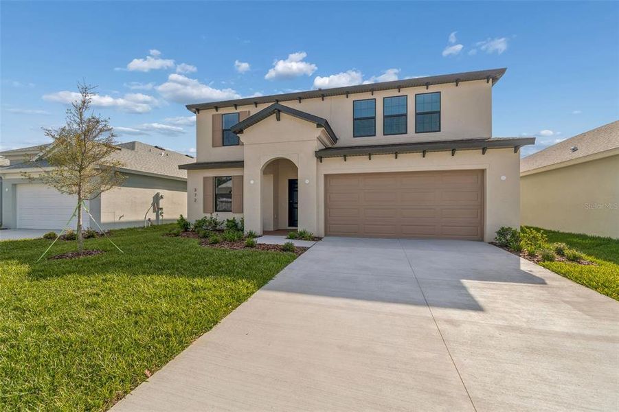 Front exterior of a new home in Avalon West, Spring Hill, FL, highlighting curb appeal (Image 31).