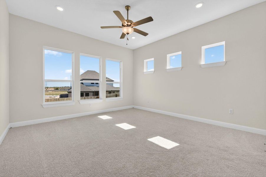 Spare room featuring light carpet, ceiling fan, and recessed lighting