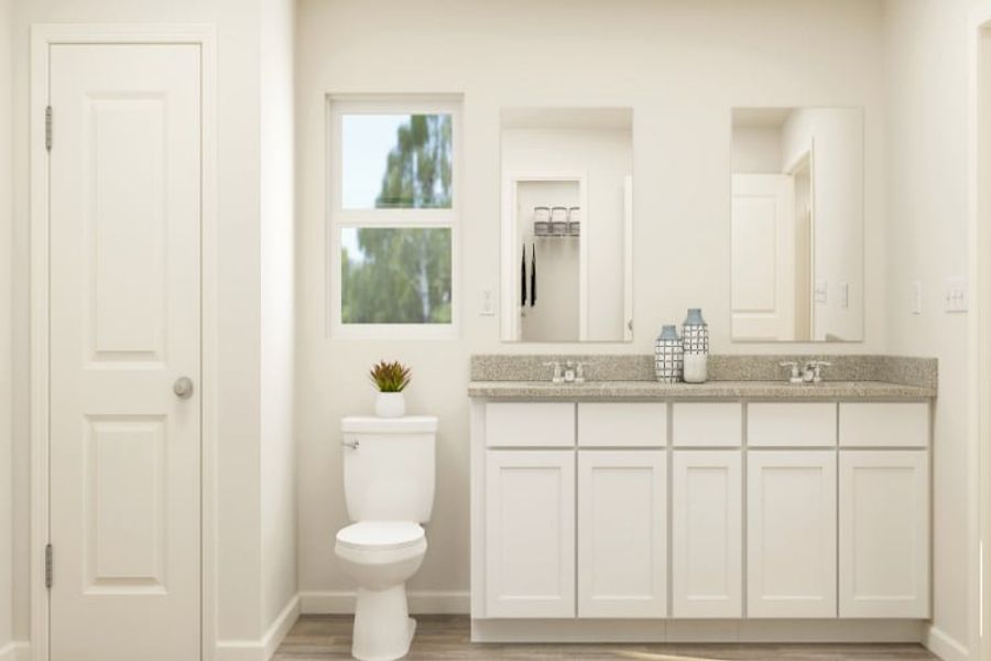 A bathroom with white cabinets. A bathroom with white cabinets.