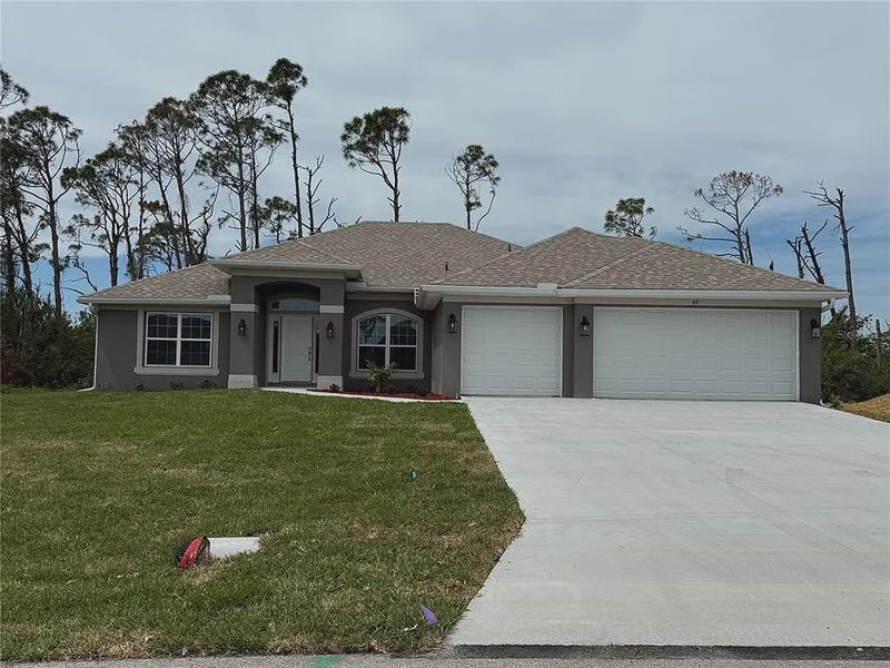 Front exterior of a new home in Rotonda, Rotonda West, FL, highlighting curb appeal (Image 1). Front exterior of a new home in Rotonda, Rotonda West, FL, highlighting curb appeal (Image 1).