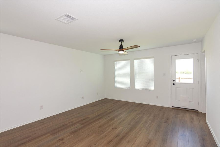 The living showcases the gorgeous vinyl plank flooring.