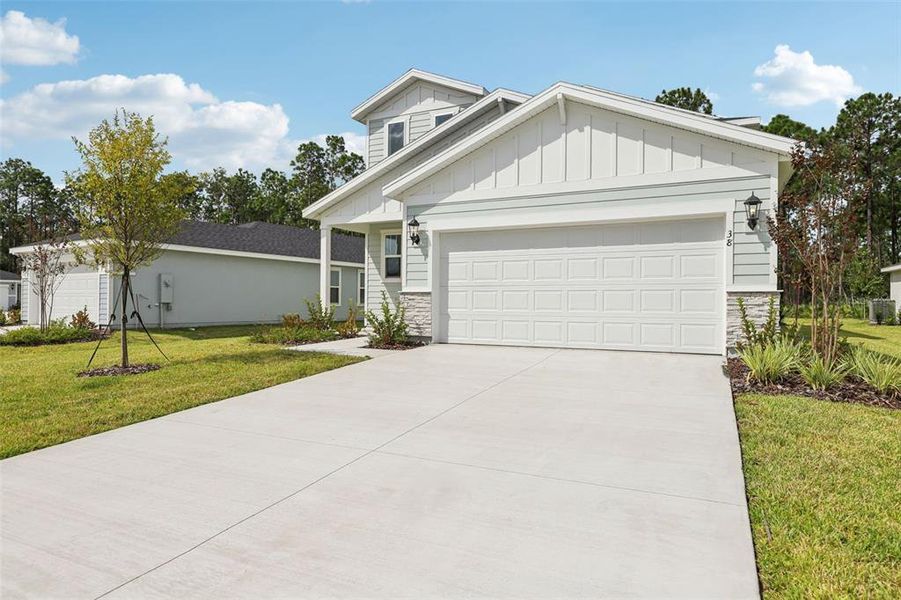 Front exterior of a new home in Flagler Village - Classic Series, Palm Coast, FL, highlighting curb appeal (Image 2). Front exterior of a new home in Flagler Village - Classic Series, Palm Coast, FL, highlighting curb appeal (Image 2).