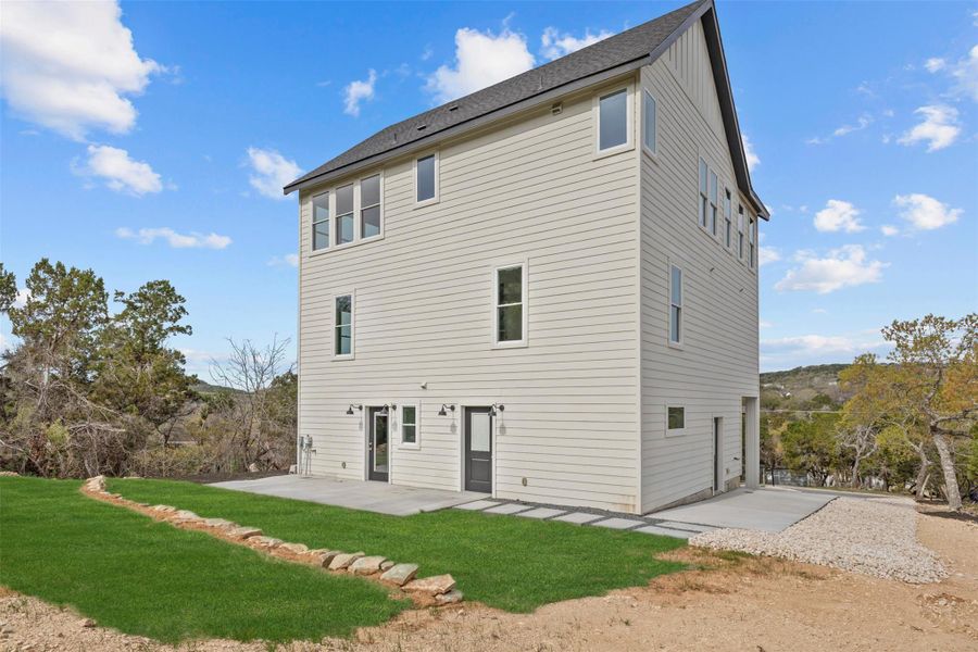Back of property featuring a patio and a yard