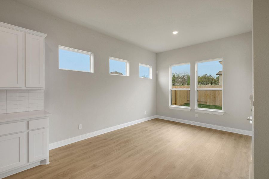 Empty room with light wood-style floors, baseboards, and recessed lighting Empty room with light wood-style floors, baseboards, and recessed lighting