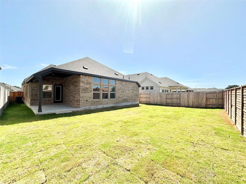 Fenced backyard featuring a patio Fenced backyard featuring a patio