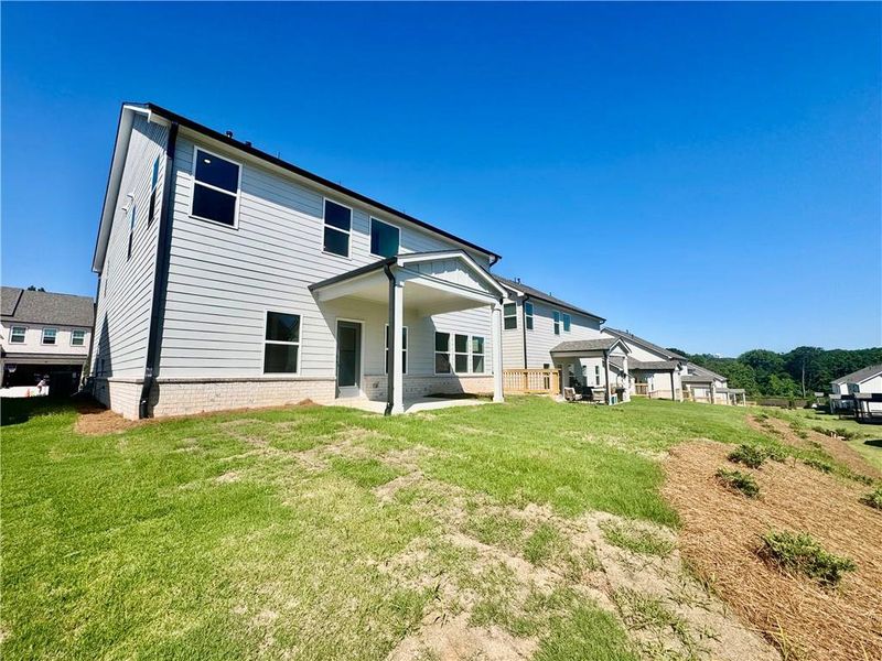 Exterior details and patio area of a home in Eastlyn Crossing, Flowery Branch (Image 19).