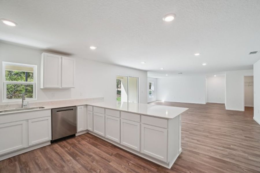 A kitchen with white cabinets.