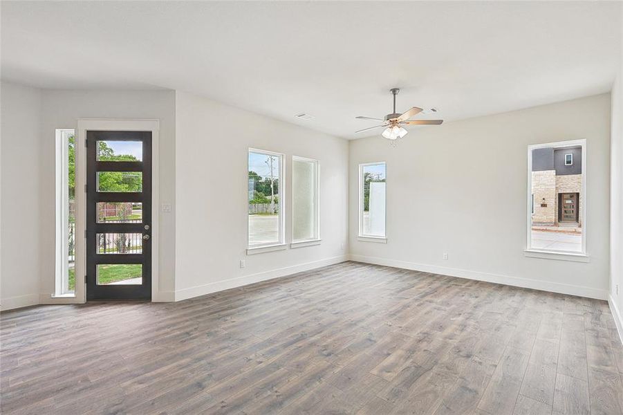 Spare room with wood-type flooring and ceiling fan